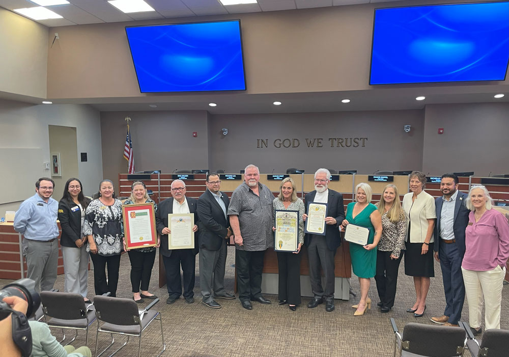 AVTA Board Members at City Hall holding up various certificates. 