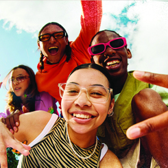 A group of students smiling and cheering.