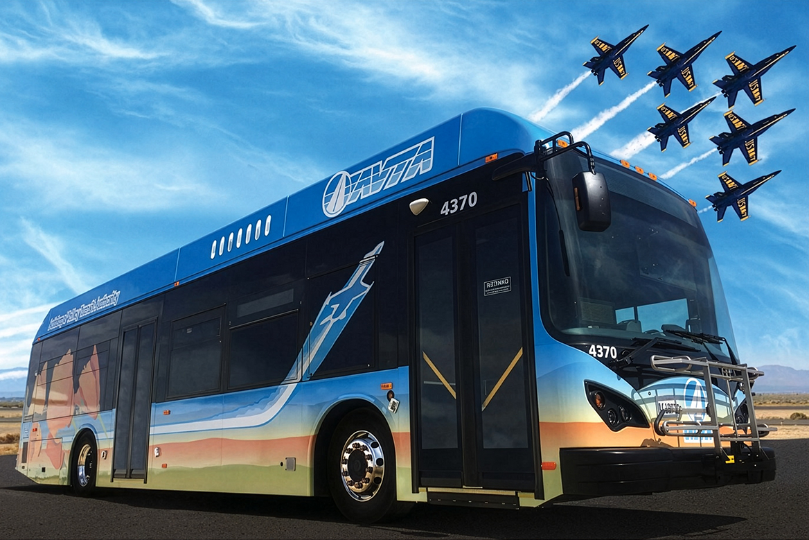 AVTA Bus side profile with the Blue Angels Flying by in the background.