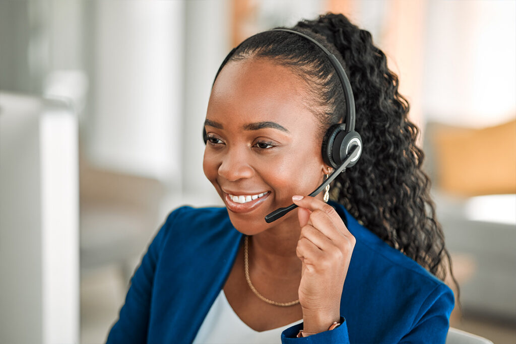 A happy phone operator chatting to customer via headset.