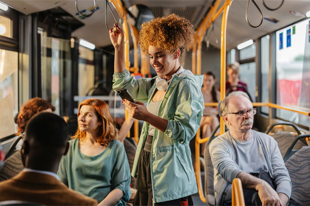 Multiple patrons happily riding the bus.