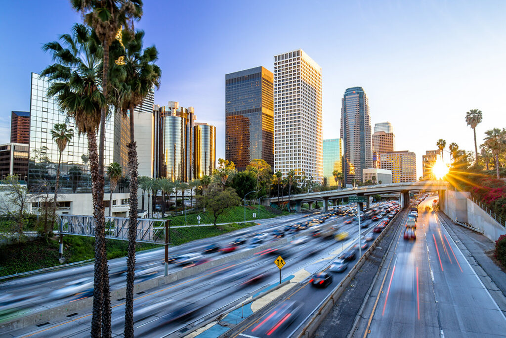 Long Exposure photo of traffic streaming by on the freeway, with downtown Los Angeles in focus.