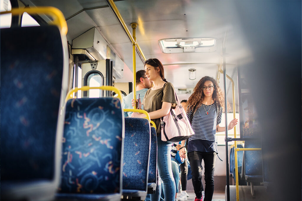 Patrons exiting the bus through the rear doors.
