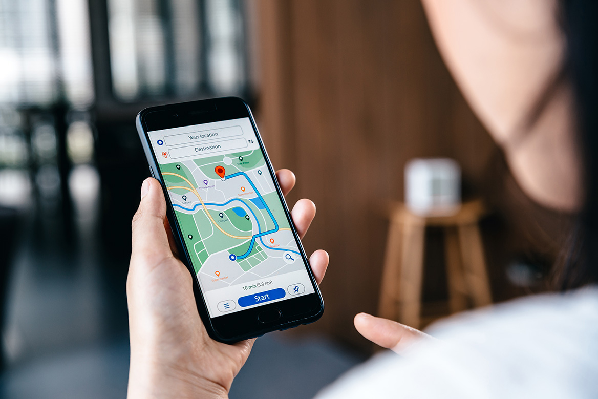 A patron planning their trip using their cell phone with a map displayed.
